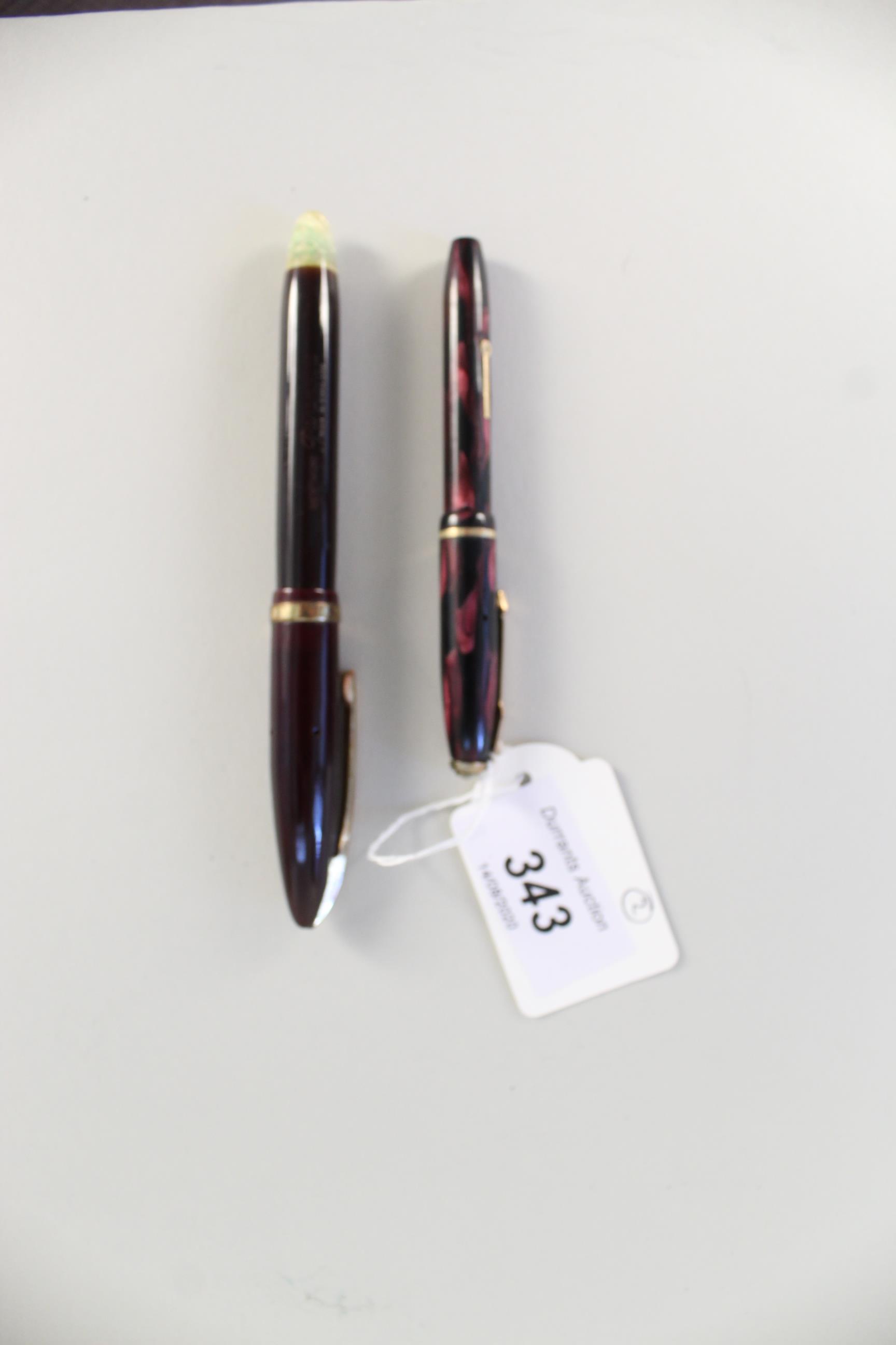 A Conway Stewart Dinkie 550 ink pen together with a Menthore Paramount pen,