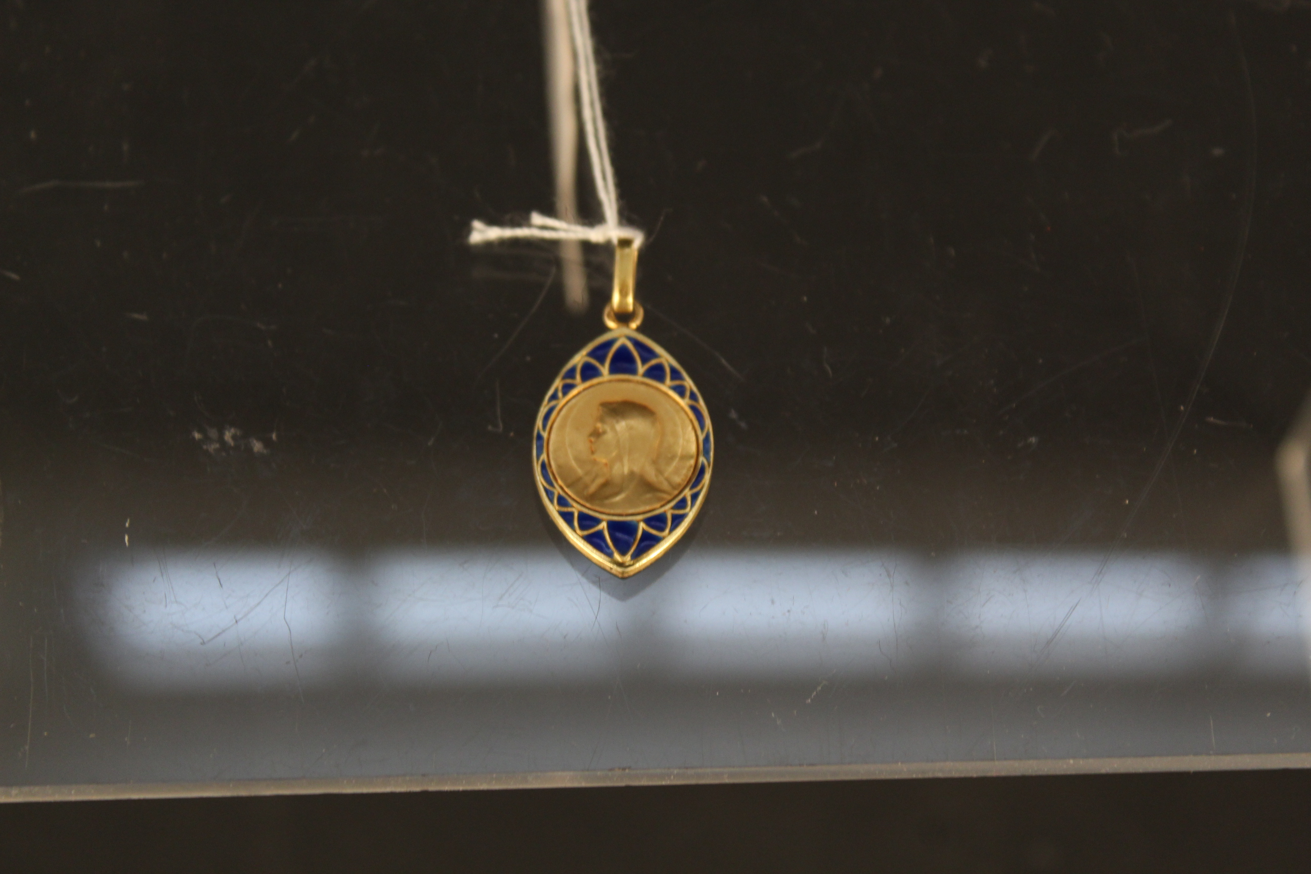 A French 18ct gold blue enamel decorated religious pendant,