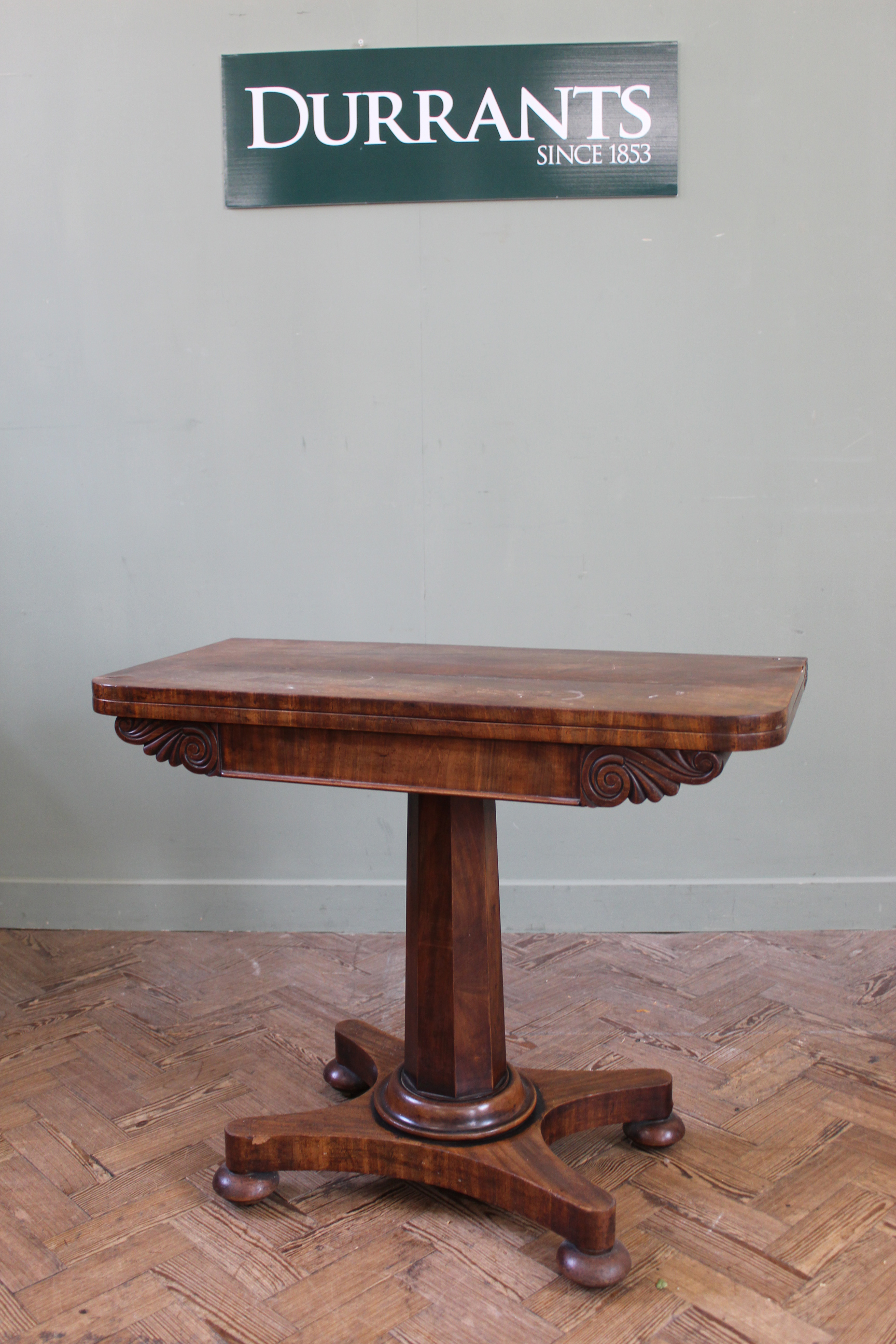 A William IV mahogany card table on hexagonal column and platform base (top as found),