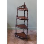 A mid Victorian rosewood four tier corner whatnot on barley twist supports,