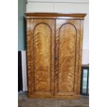 A mid 19th Century satin birch two door two part wardrobe with fitted drawers to interior,