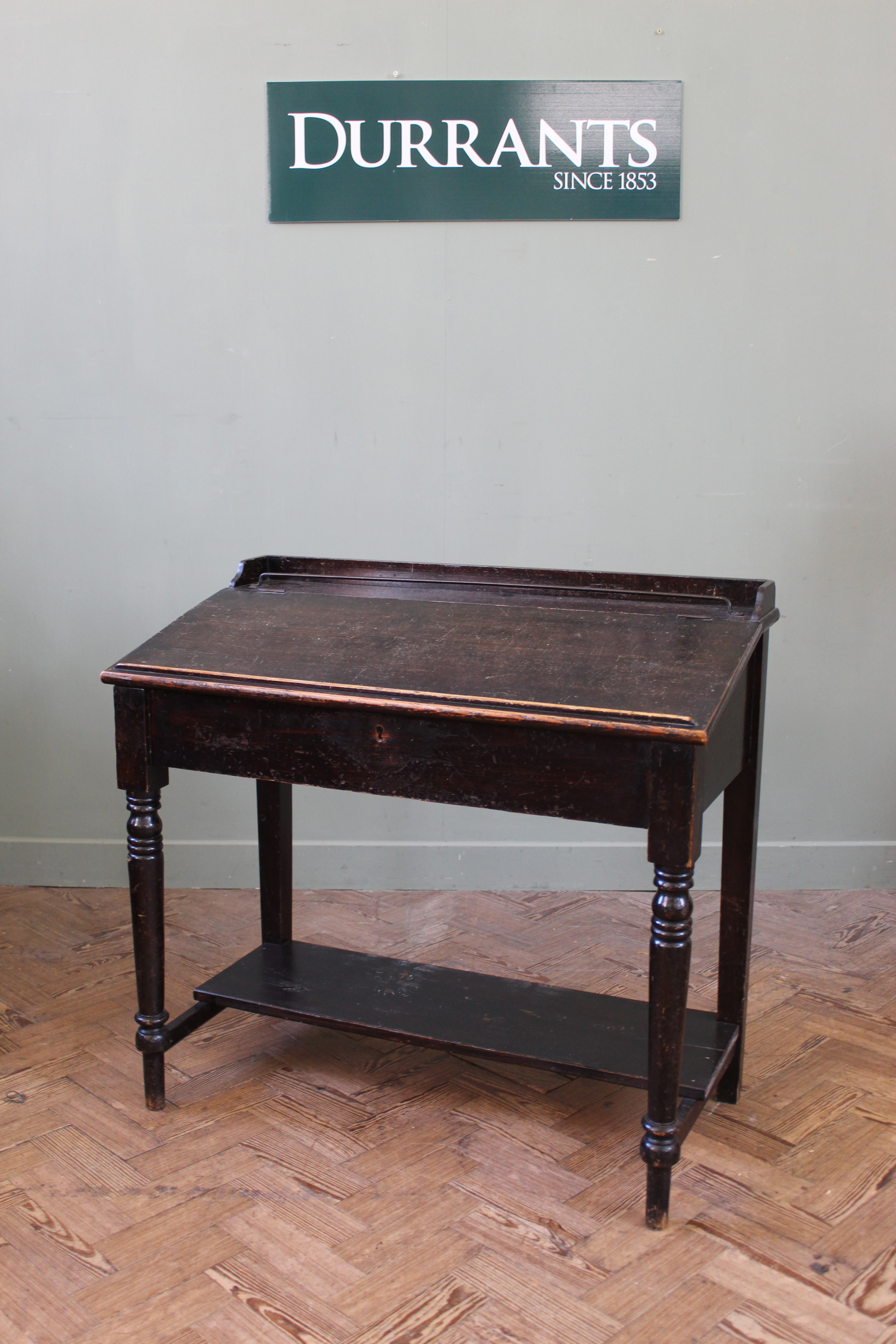 A late 19th Century stained pine slope front desk, lift up top with fitted interior,