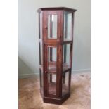 A mahogany hexagonal shops display cabinet with two doors and glazed all round,