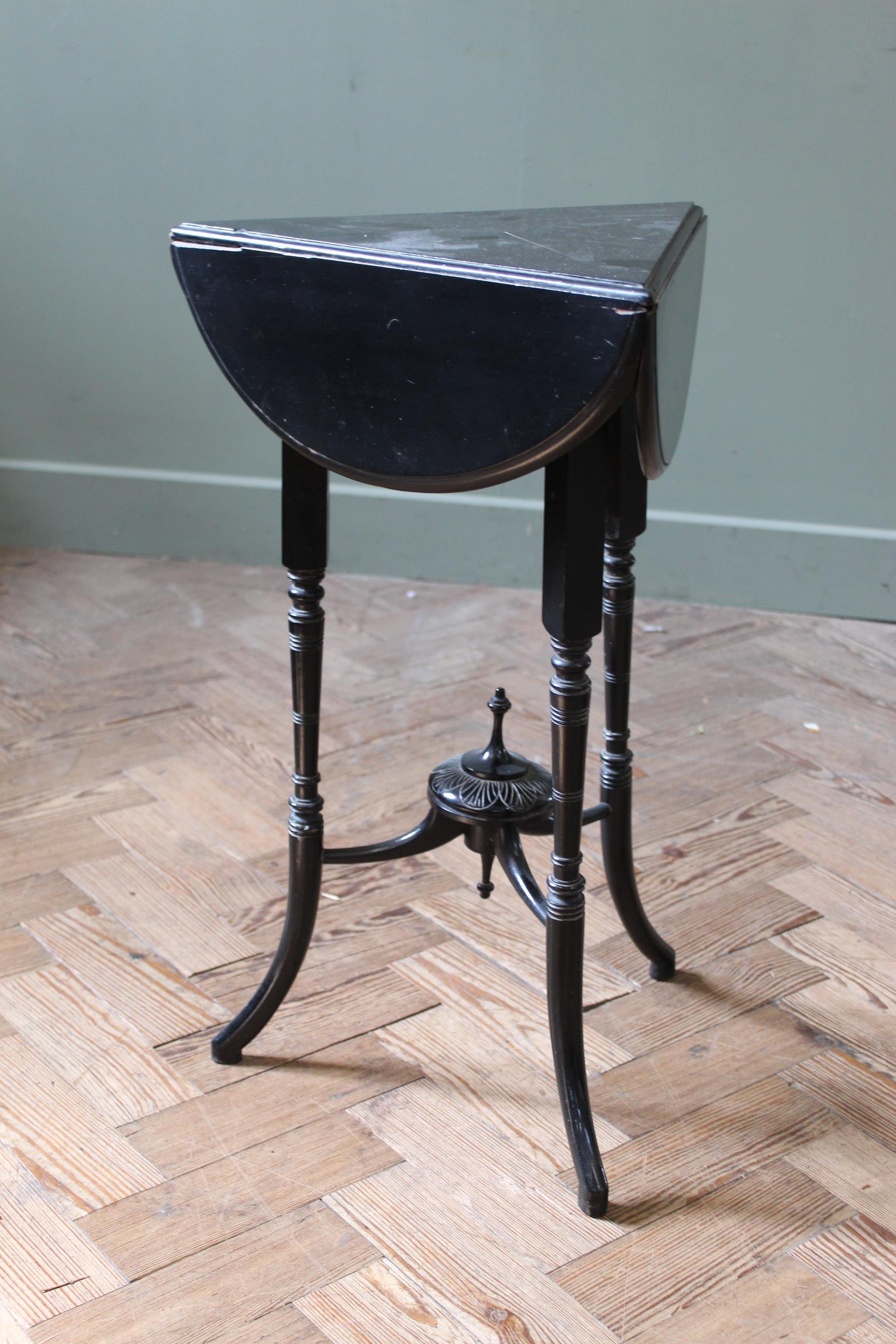 A late Victorian ebonised envelope table top (max) 20" x 25" high