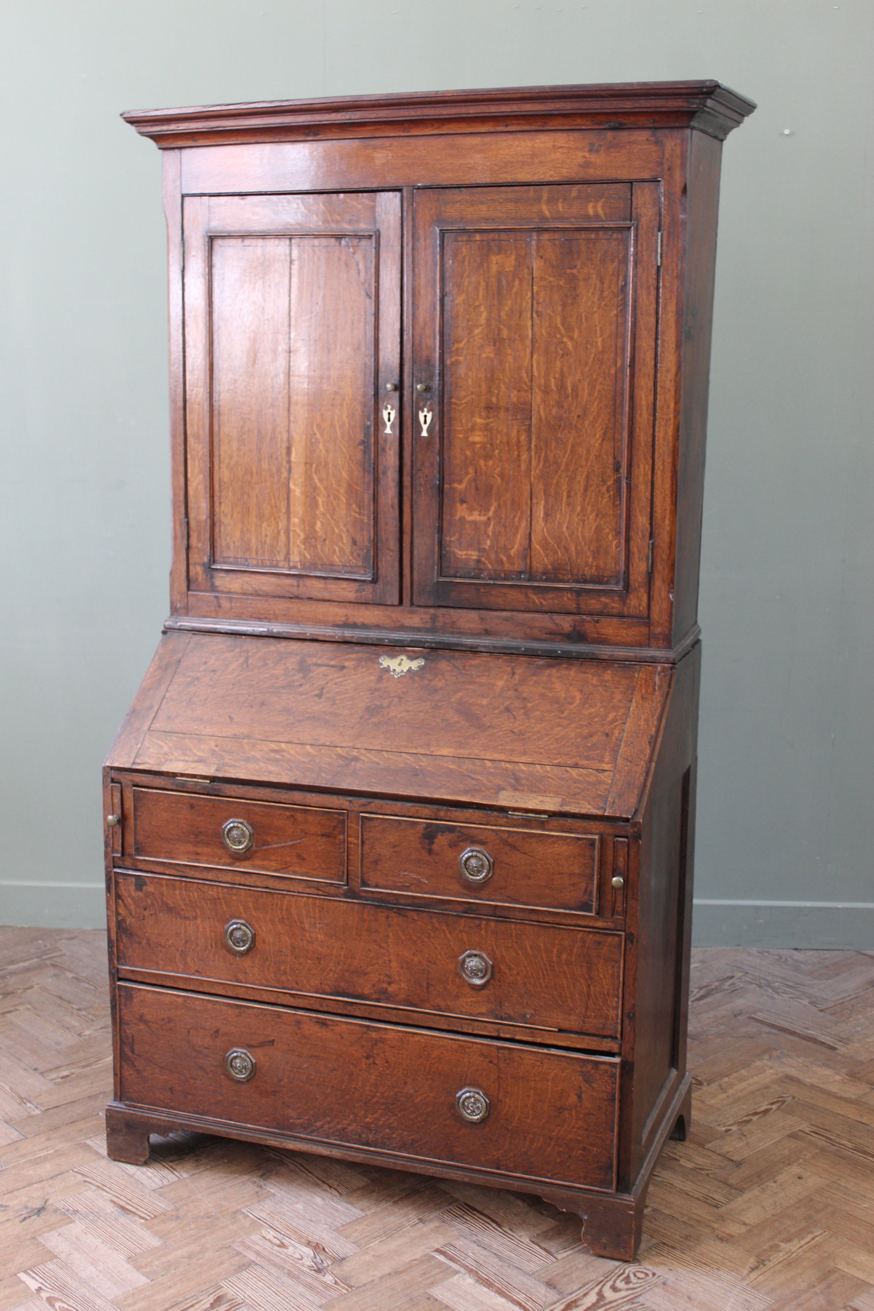 An early 19th Century country oak bureau bookcase, fitted interior,
