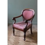 A William IV mahogany library/desk chair with acanthus leaf carving to the scroll arms,