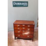 A George III mahogany four drawer chest on splay feet