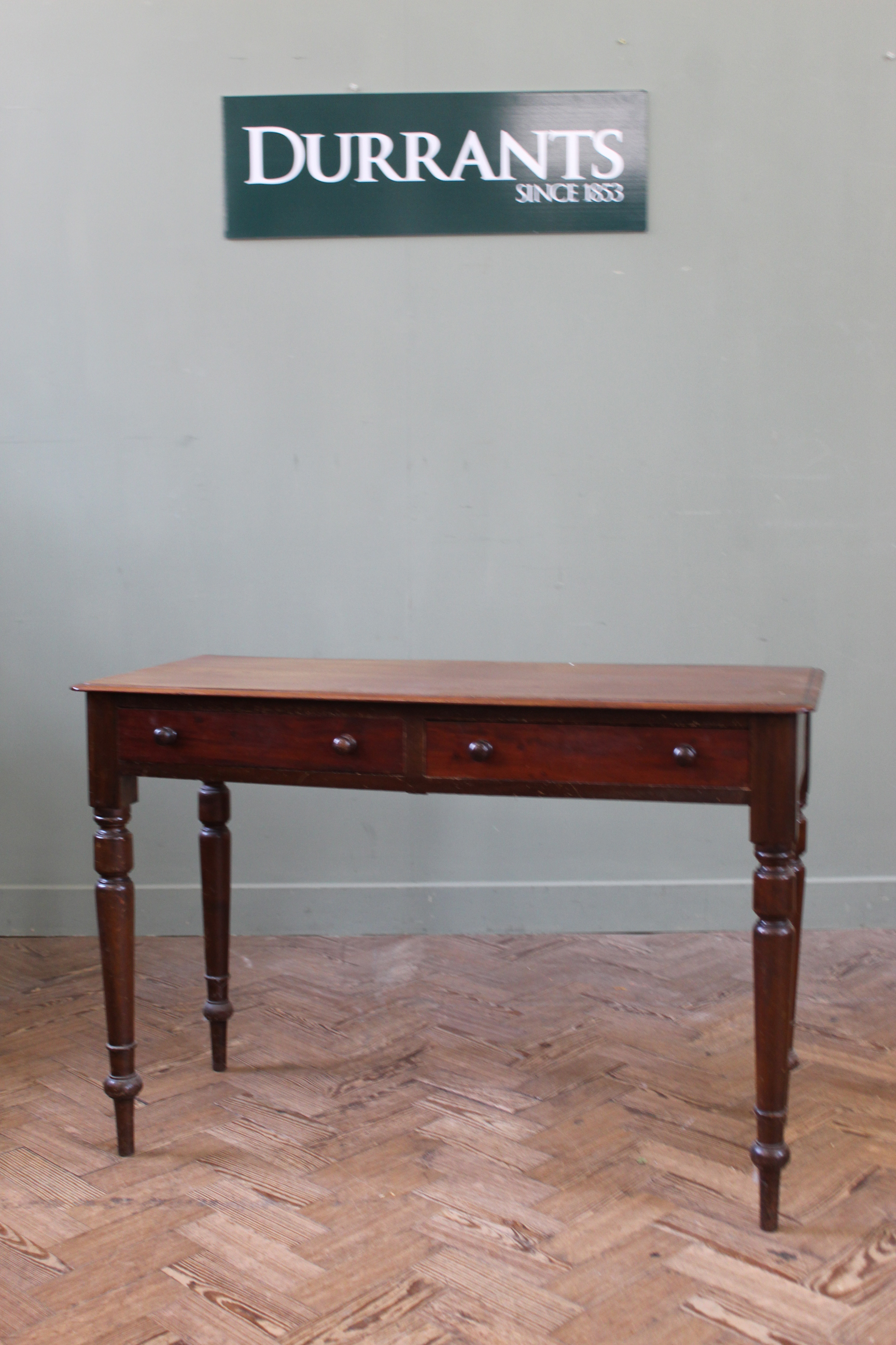 A late Victorian mahogany two drawer writing table,