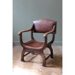 An Edwardian oak "X" framed chair with leather seat and back