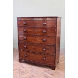 An early 19th Century mahogany chest of six drawers on shaped bracket and apron,