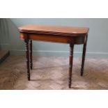 A 19th Century mahogany tea table with turned legs