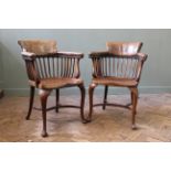 A pair of Edwardian mahogany desk chairs on cabriole legs with crinoline stretchers,