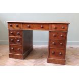 A mid Victorian mahogany three part pedestal desk with later leather inset top,