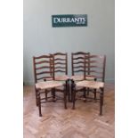 A set of four oak ladder back chairs with rush seats, c1910,