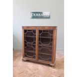 A 1930's astragal glazed mahogany bookcase, in the Georgian style on ogee bracket feet,