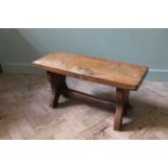 A cottage oak coffee table on end stretchers,