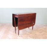 An early 19th Century mahogany drop leaf table,