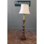 A giltwood standard lamp