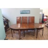 A George III sectional mahogany dining table,