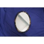 A 1920's Chinoiserie decorated oval wall mirror