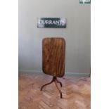 An early 19th Century mahogany tripod table with rectangular top