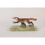 A cold painted bronze figure of a running fox on onyx base