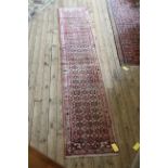 A Persian Hearti design runner, on a pink ground,