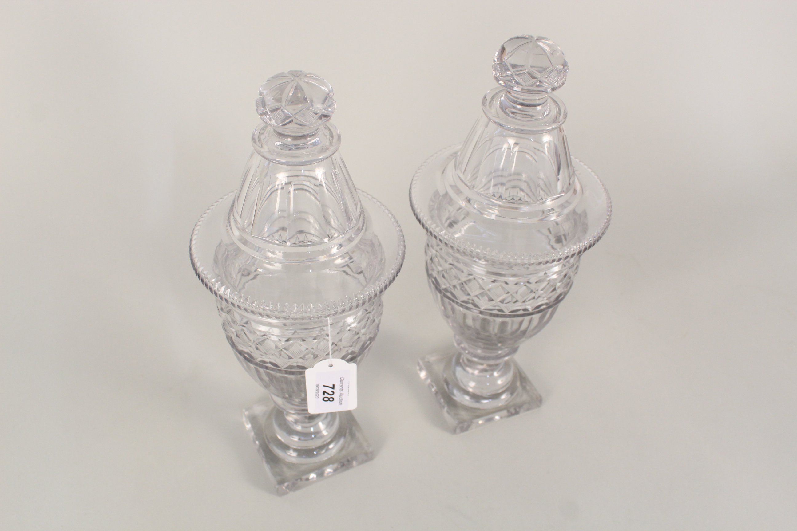 A pair of Georgian cut glass lidded jars, possibly Irish, height 12 1/2",