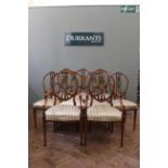 An Edwardian satinwood seven piece salon suite comprising four side chairs,