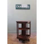 An Edwardian inlaid mahogany revolving bookcase