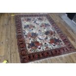 A Turkoman rug on white ground with a pink border,