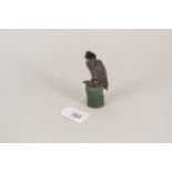 A silver model of a hawk with real feathers on top, mounted on green stone base hallmarked London,