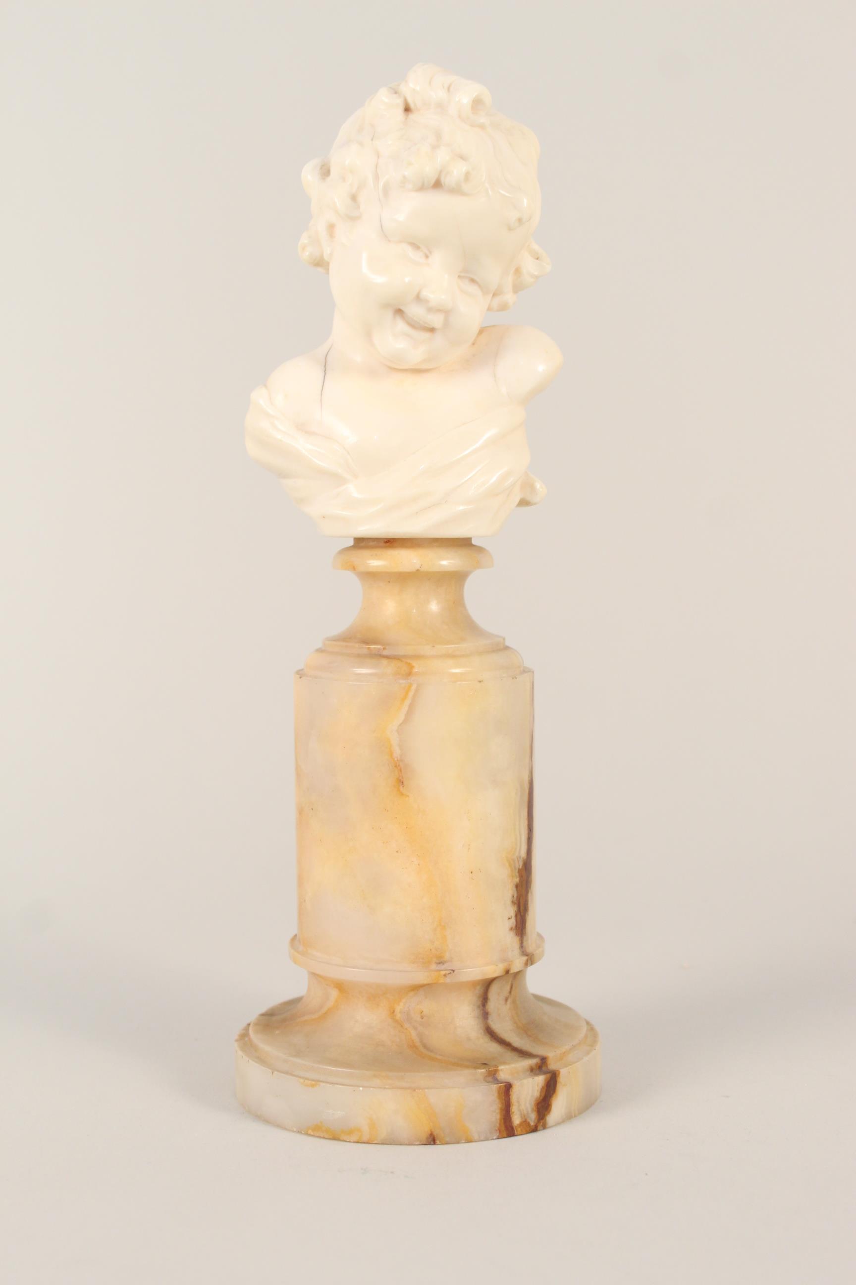 An ivory bust of an infant mounted on an alabaster base, signed Jose de Creeft,