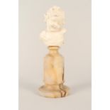 An ivory bust of an infant mounted on an alabaster base, signed Jose de Creeft,