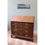 A George III bureau veneered in burr yew with mahogany sides and mahogany cross banding to drawers.