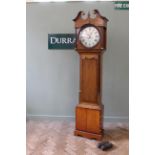 An early 19th Century oak and mahogany longcase clock with eight day striking movement and round