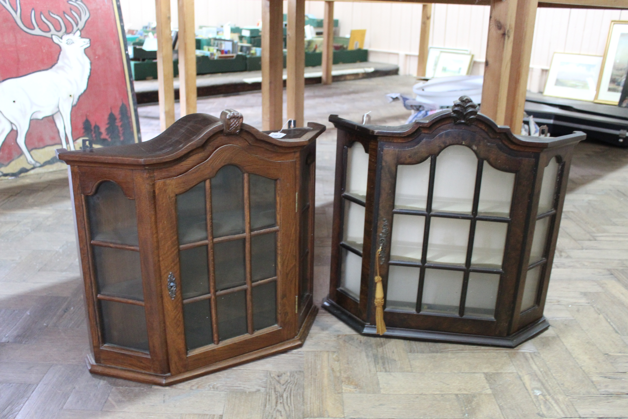 Two vintage oak collectors display cabinets, one with key,