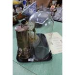 A Gustan & Becker brass clock under glass dome,