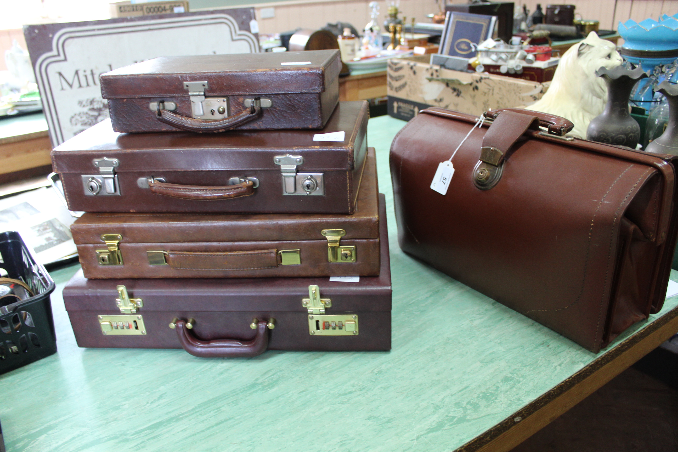 Five vintage brown leather briefcases plus a Gladstone style bag