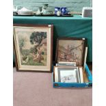 A selection of pictures including a tapestry of a street, two framed photographs of beach scenes,