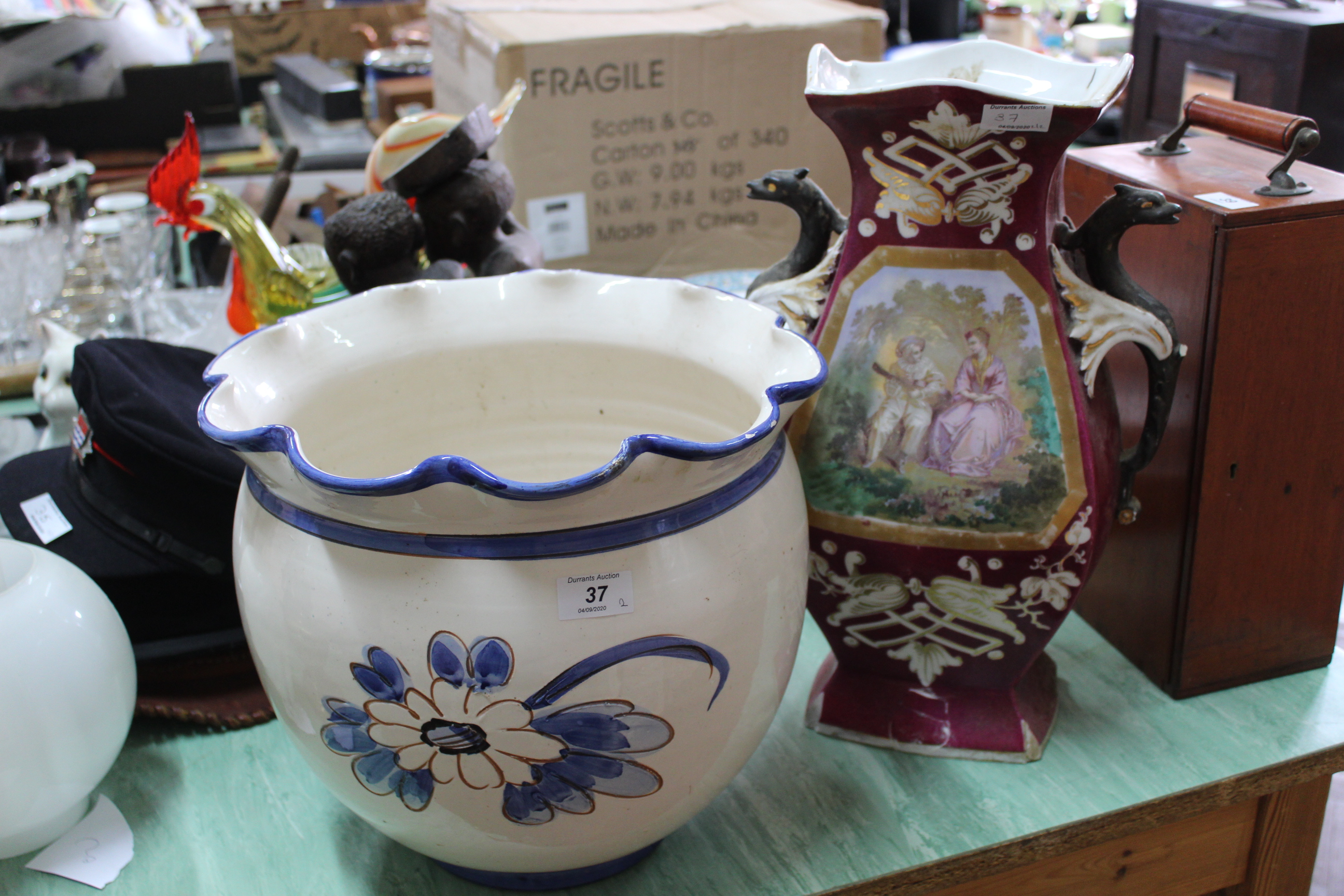 A large floral decorated planter together with a large continental pink decorated vase with dragon