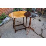 A Victorian oak tripod and barley twist table