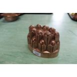 A Victorian oval copper jelly mould of turret form by Benham & Froud No.