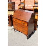 An Edwardian mahogany three drawer bureau