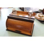 An Edwardian oak tambour front stationary box with drawer and two inkwells