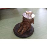 An alligator foot inkwell with white metal top and lid,