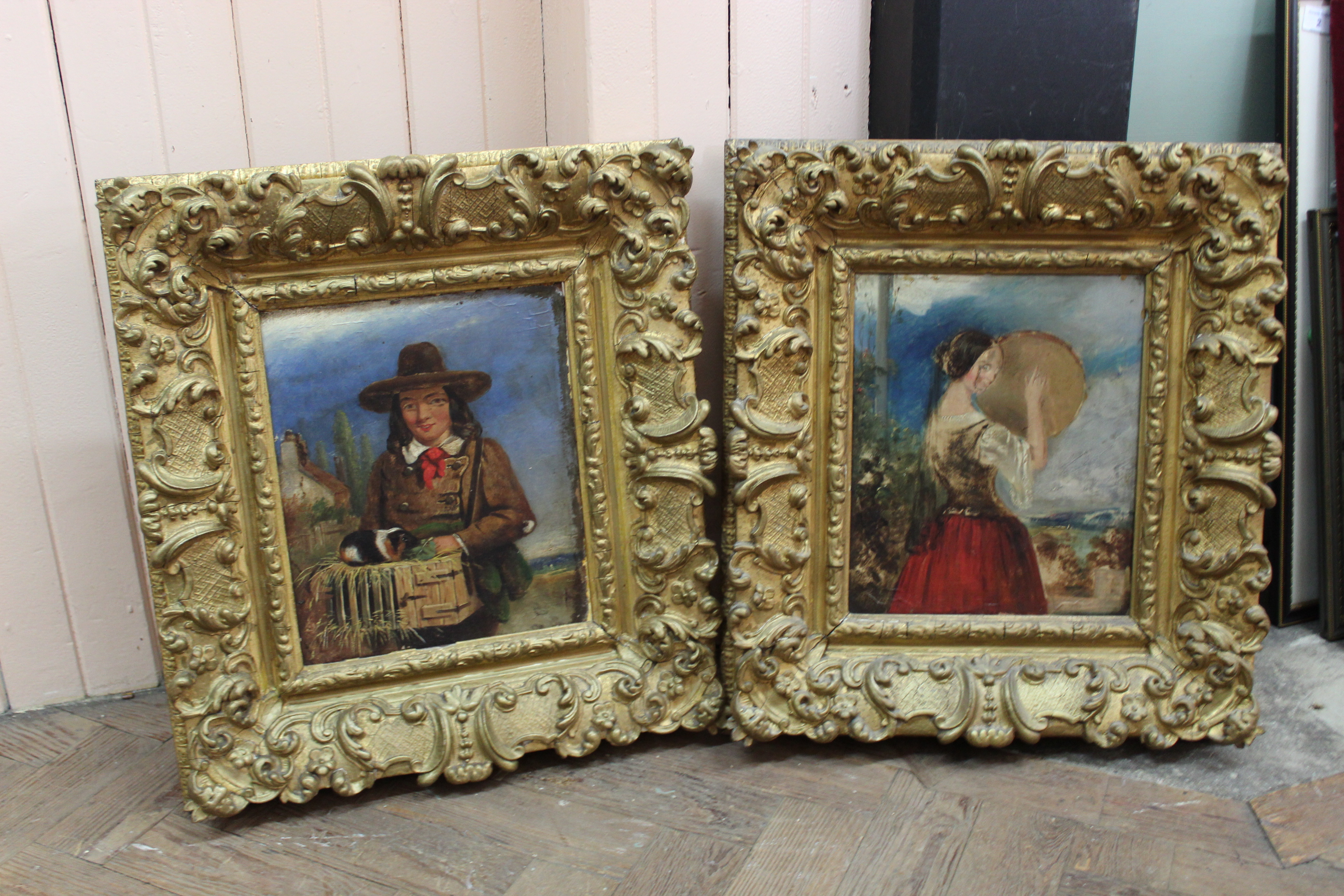 A pair of late 19th Century oil portraits of a boy with a guinea pig and a girl with a tambourine