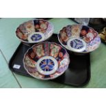 Three Imari petal edged bowls with floral and trellis panels