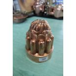 A tall Victorian circular copper jelly mould of turret form by Benham & Froud, No.