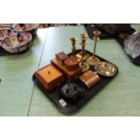 A tray with two pairs of brass candlesticks, wooden boxes,